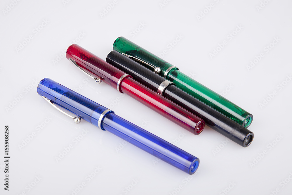 Colorful pens on a white surface. Pens isolated on white background.