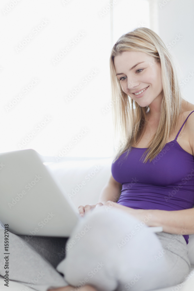 Smiling teenage girl using laptop Smiling teenage girl using laptop