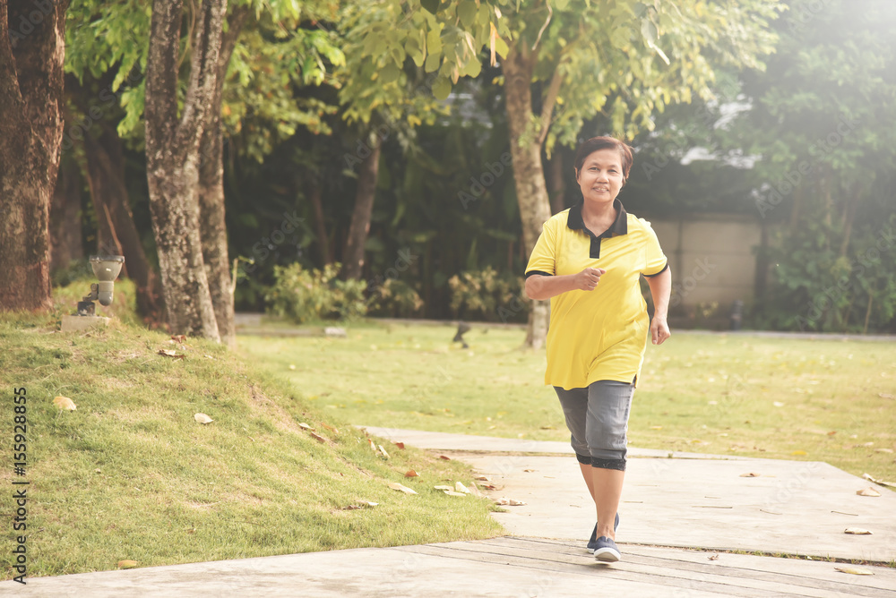 Asian senior woman relaxing with jogging at park outdoor. Happiness. Asian senior woman relaxing with jogging at park outdoor. Happiness.