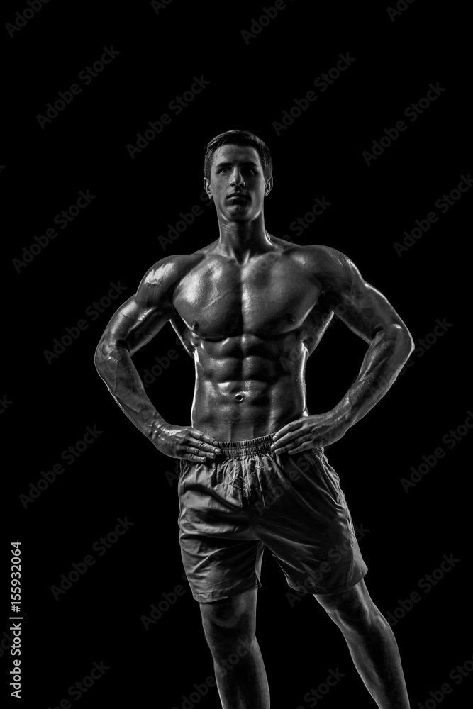 Muscular and fit young bodybuilder fitness male model posing ove Muscular and fit young bodybuilder fitness male model posing ove