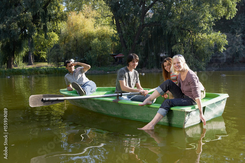 Photography Four friends in a rowboat smiling