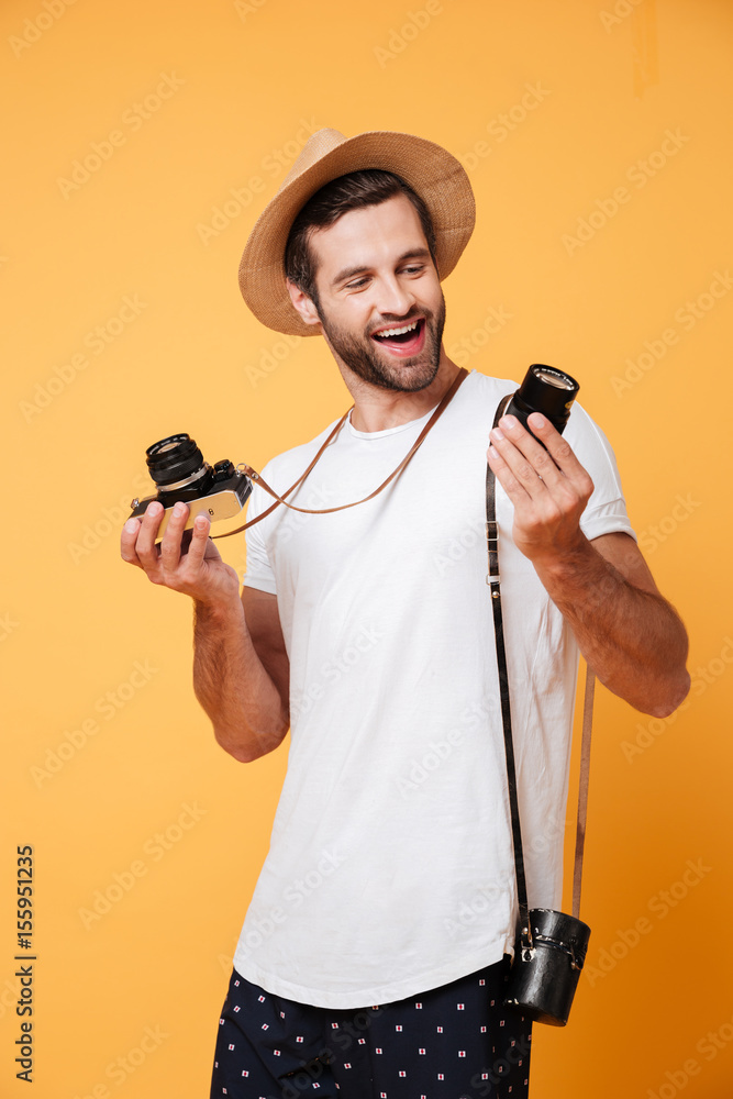 Smiling man looking at lens for his camera Smiling man looking at lens for his camera