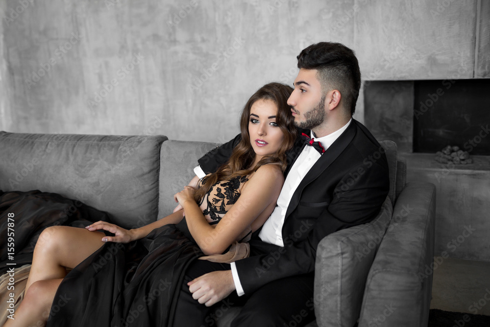 Woman in elegant dress sitting with handsome man in black suit. Woman in elegant dress sitting with handsome man in black suit.