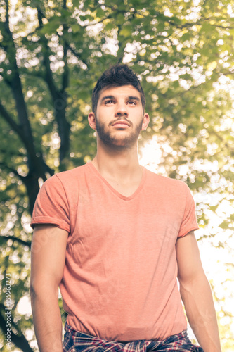one young man, upper body portrait, low angle view