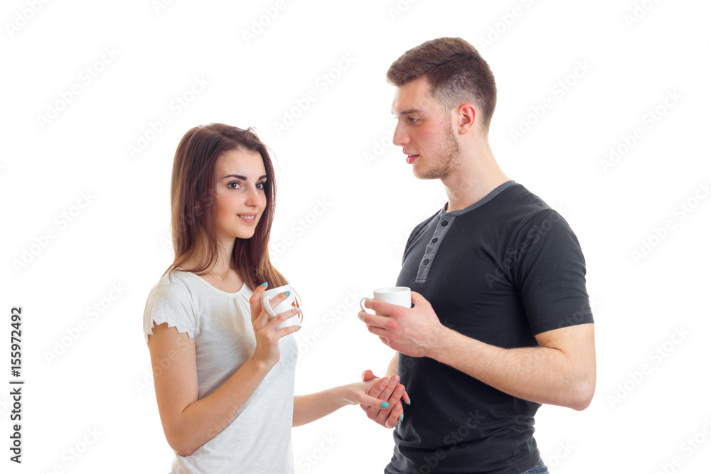 smiling beautiful girl with nice guy talks and they are holding Cup smiling beautiful girl with nice guy talks and they are holding Cup