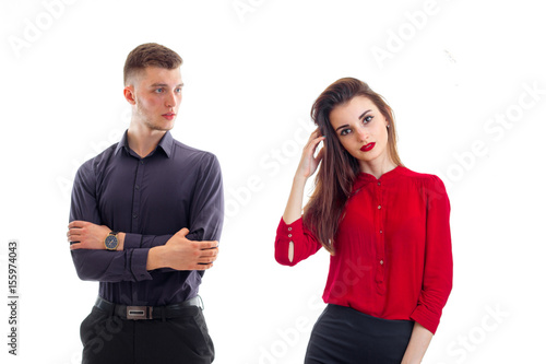 charming serious guy worth hands clasped near the beautiful girl with red lipstick and red blouse