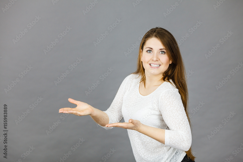 Happy woman presenting copyspace with hands Happy woman presenting copyspace with hands