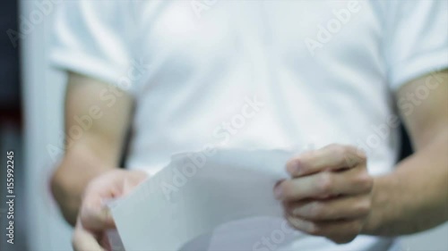 Calm Man tearing paper