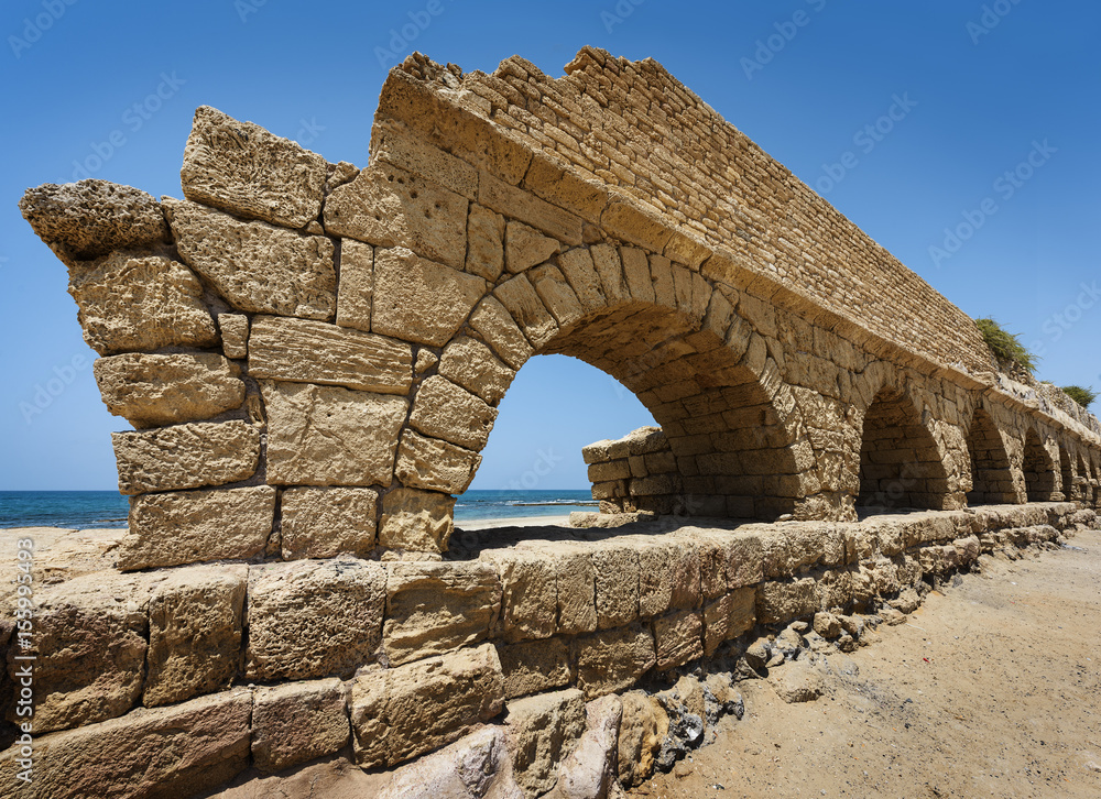 Ancient Roman aqueduct in Ceasarea at the coast of the Mediterranean Sea, Israel