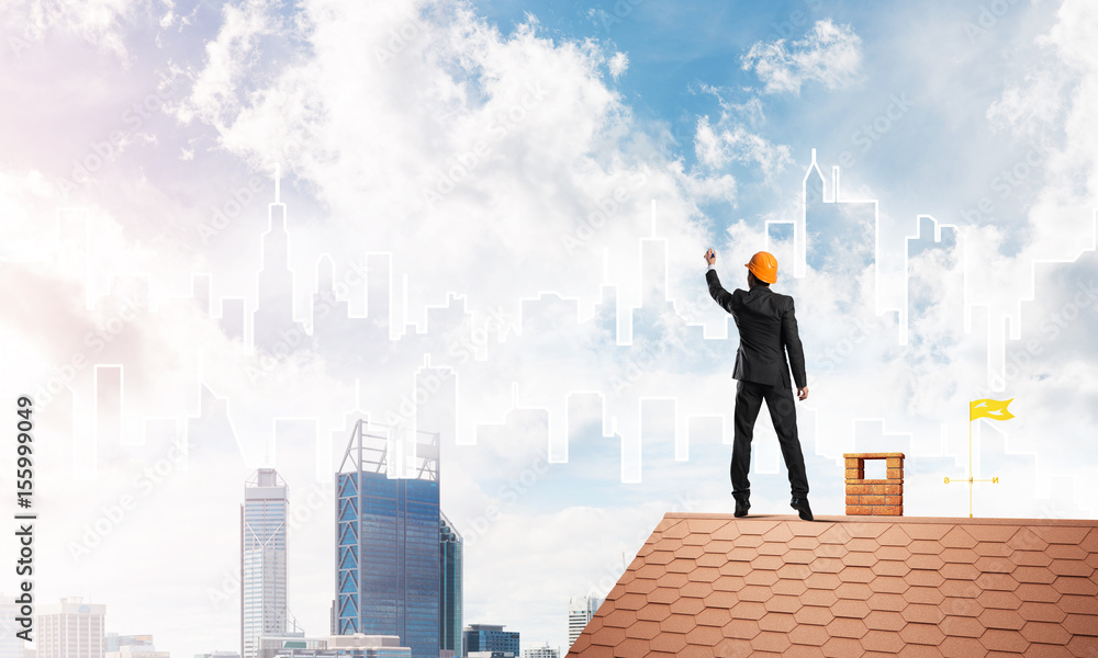 Man architect draw silhouette of modern city on blue sky. Mixed media Man architect draw silhouette of modern city on blue sky. Mixed media