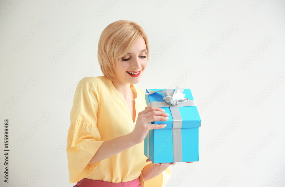 Beautiful woman holding gift box on white background Beautiful woman holding gift box on white background