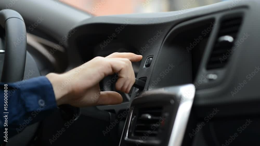 Man starting and turning off engine with engine start stop button Man starting and turning off engine with engine start stop button