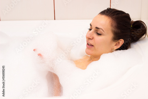 Young woman lying in the bath