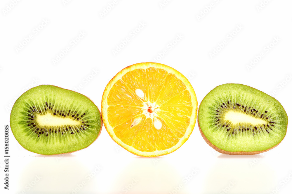 Fruit trio composition made of kiwi fruit and orange halves Fruit trio composition made of kiwi fruit and orange halves