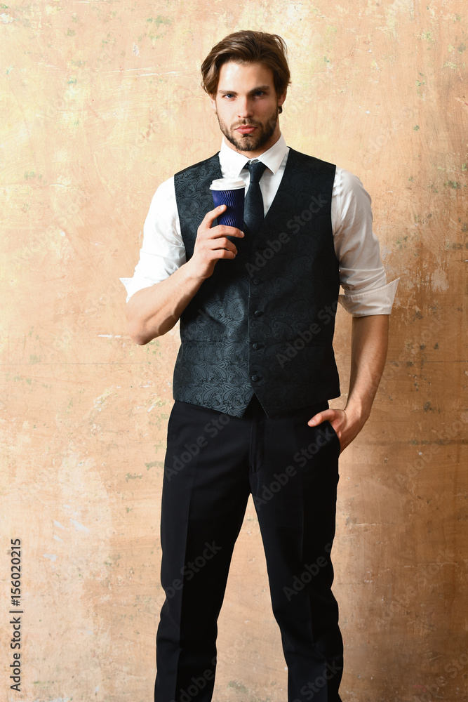 morning coffee, young serious business man holding paper cup morning coffee, young serious business man holding paper cup