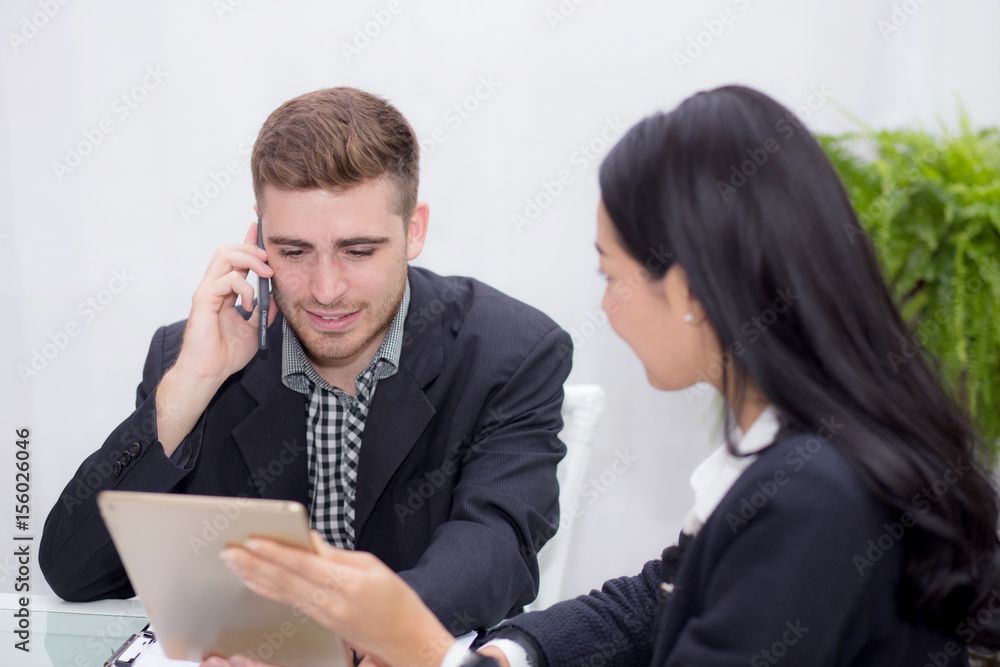 business man and woman people making meeting and looking at tablet for analyzing marketing working at office on desk. business man and woman people making meeting and looking at tablet for analyzing marketing working at office on desk.