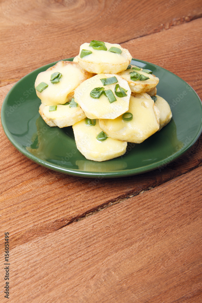 Appetizer of potatoes, cheese and green onions. There is room for text