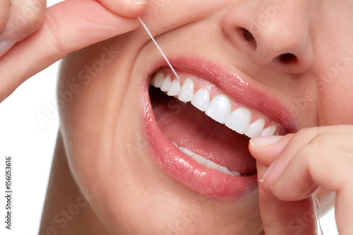 woman smile with tooth floss © grinny