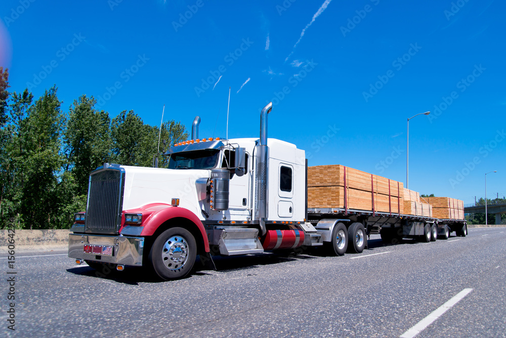 Big rig classic semi truck flat bed trailers carry lumber