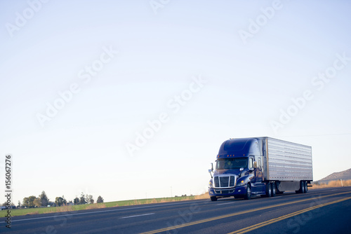 Принти на полотні Blue modern semi truck reefer trailer carry cargo on highway