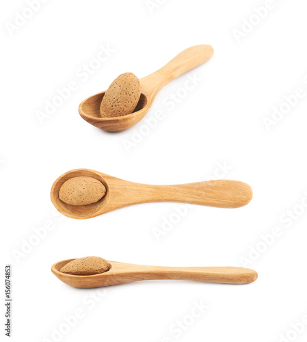 Almond nut in a wooden spoon isolated