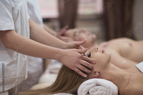 couple enjoying head massage at the spa