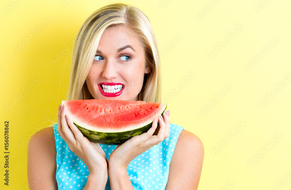 Happy young woman holding watermelon Happy young woman holding watermelon