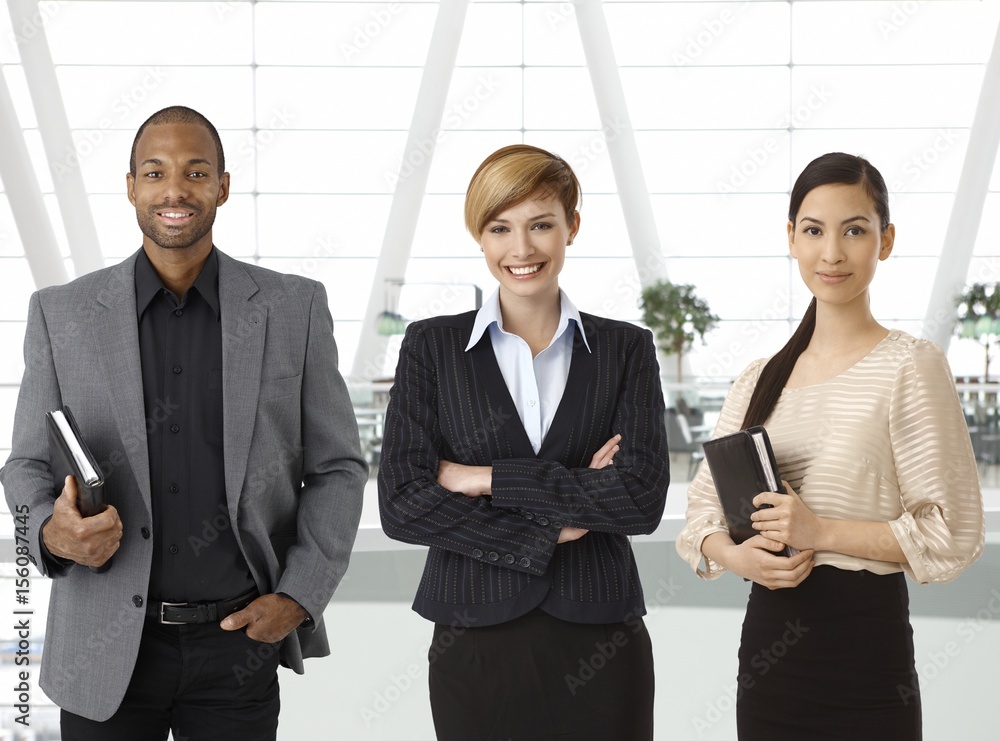 Interracial business team in business hallway Interracial business team in business hallway