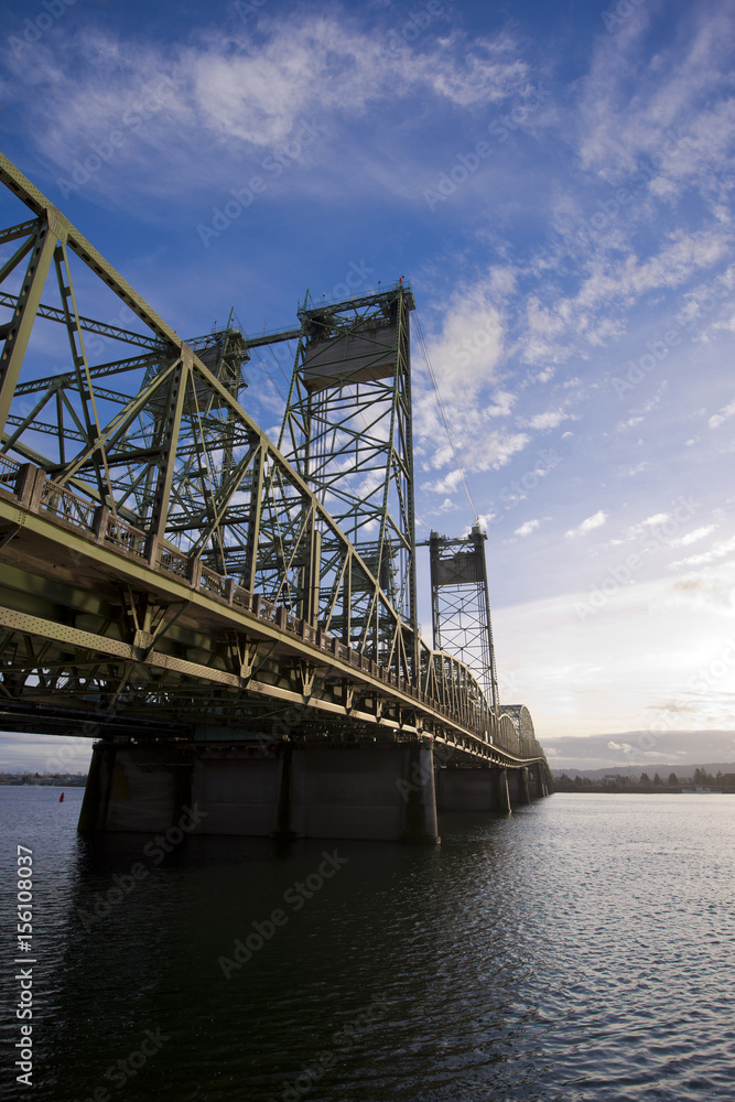 Metal truss bridge with triangles and towers across Columbia River