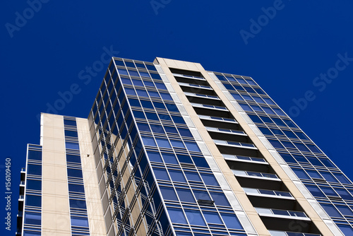Modern_glass_skyscraper_on_ background_of_blue_sky