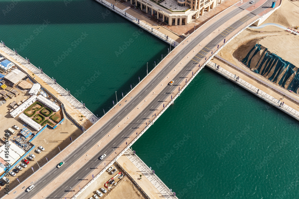 Fototapeta premium Aerial view of a highway in Dubai, UAE, with traffic. Scenic daytime skyline. Travel and architecture background.