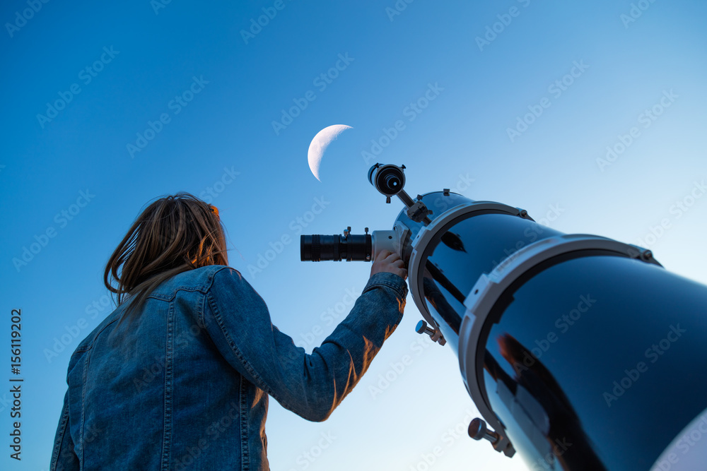 Girl looking at the Moon through a telescope. My astronomy work. - obrazy, fototapety, plakaty 