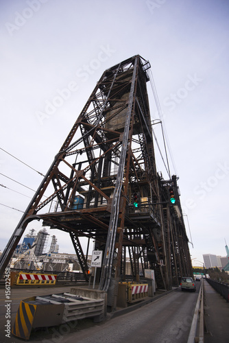 Old lifting metal structures bridge towers over river Willamette Portland in perspective