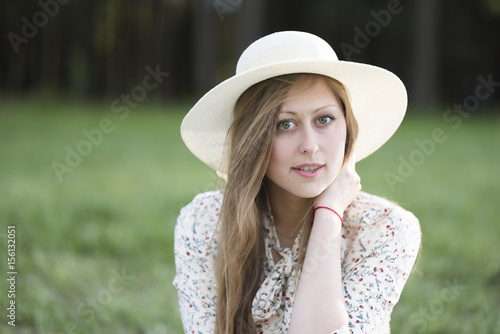 Face of a beautiful green-eyed girl in a hat