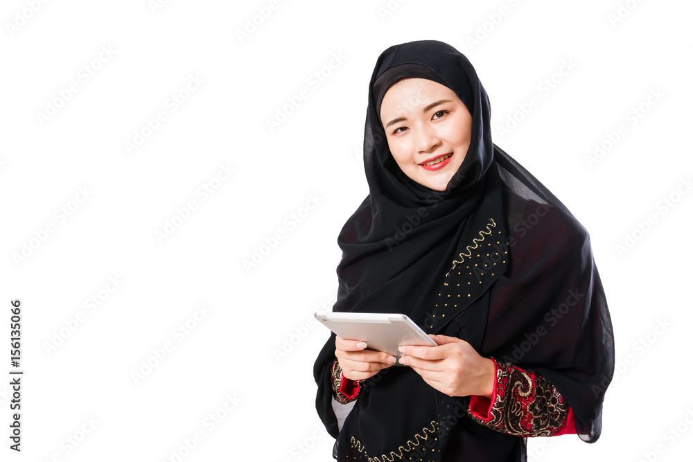 Beautiful young muslim woman using tablet pc on a white background. Beautiful young muslim woman using tablet pc on a white background.