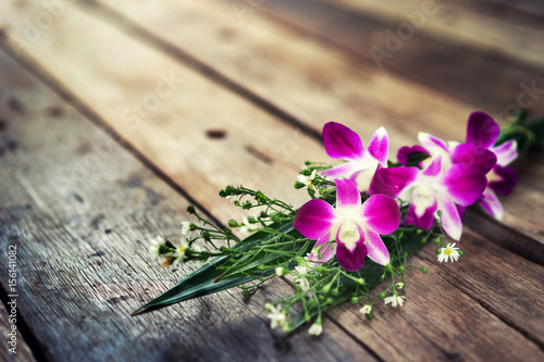 violet orchid flower on old wood background