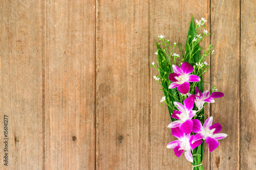 violet orchid flower on old wood background