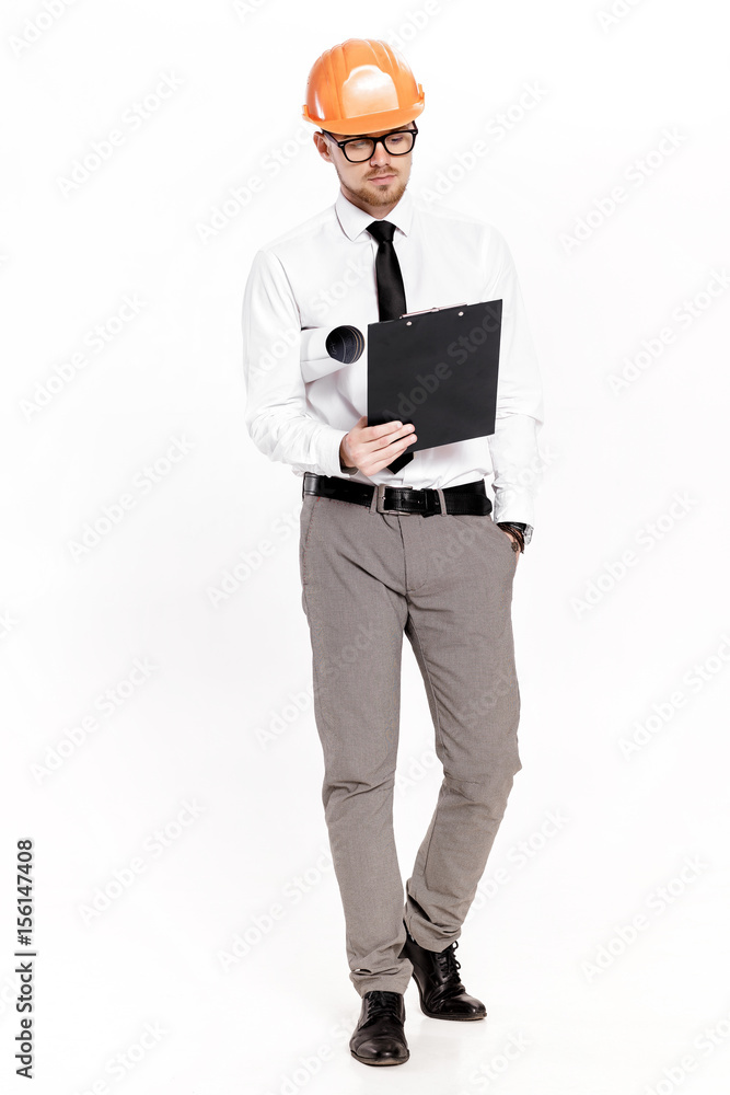 Young construction engineer in orange helmet with folder on white background Young construction engineer in orange helmet with folder on white background