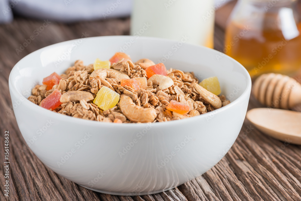 Granola with dried fruits and nuts in white bowl. Granola with dried fruits and nuts in white bowl.