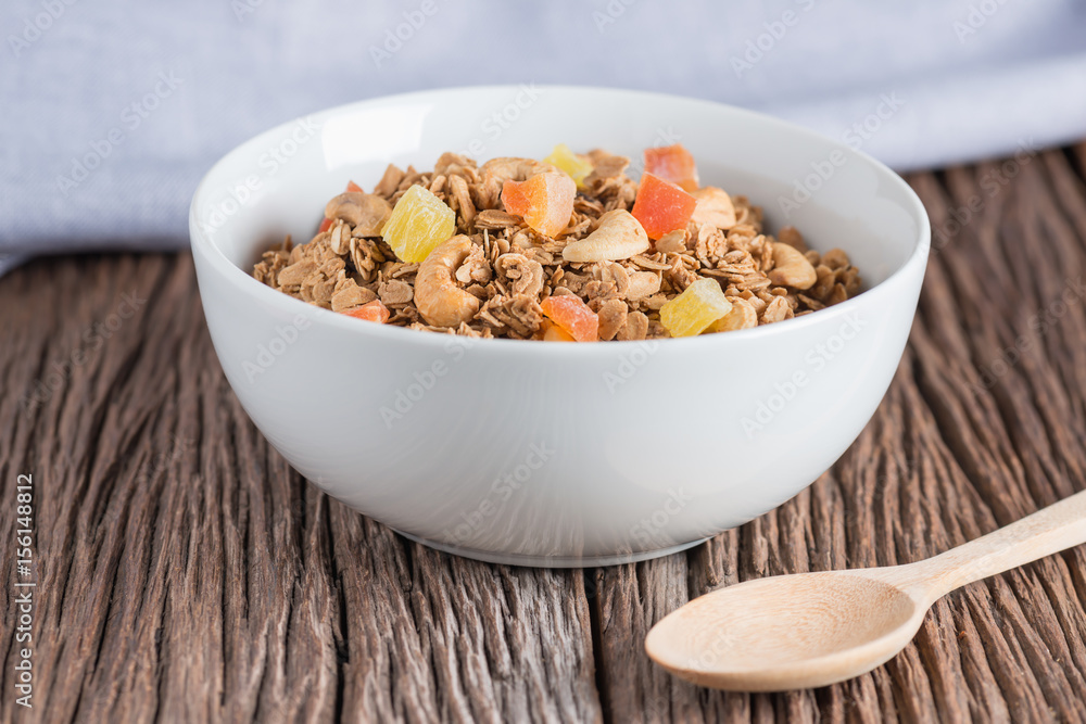 Granola with dried fruits and nuts in white bowl. Granola with dried fruits and nuts in white bowl.