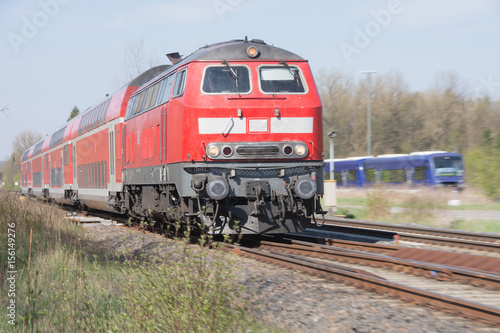Roter Triebwagen zieht Eisenbahnwaggon