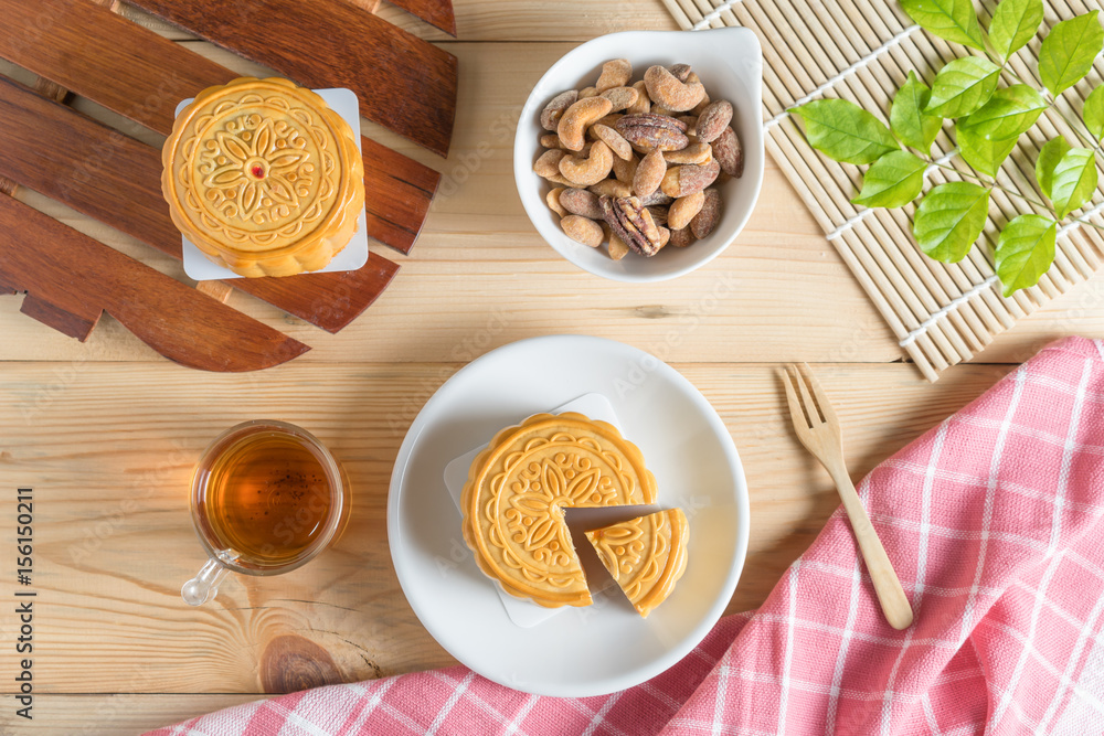 Mooncake with tea cup and nuts. Top view.