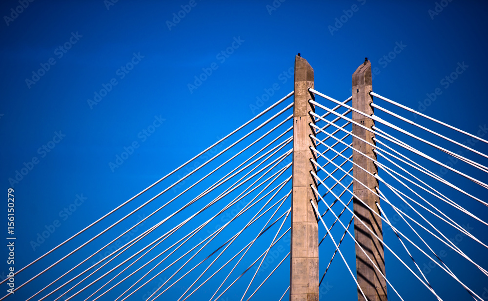Rope bridge piers stretching on blue sky background Rope bridge piers stretching on blue sky background