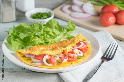 Omelet with shallot and cherry tomato.