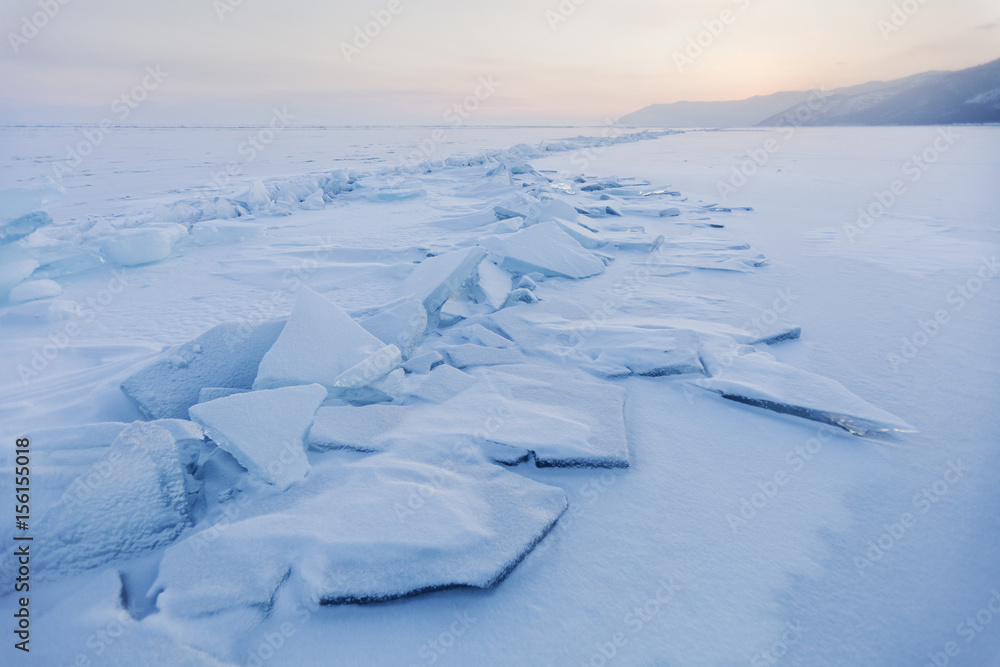 Turquoise ice floes. Winter sunset landscape.