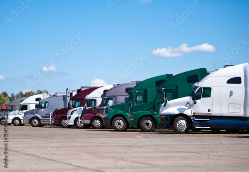 Semi trucks lined up on truck stop classic and modern