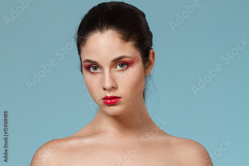 Fashion portrait of girl with bright make up looking at camera.