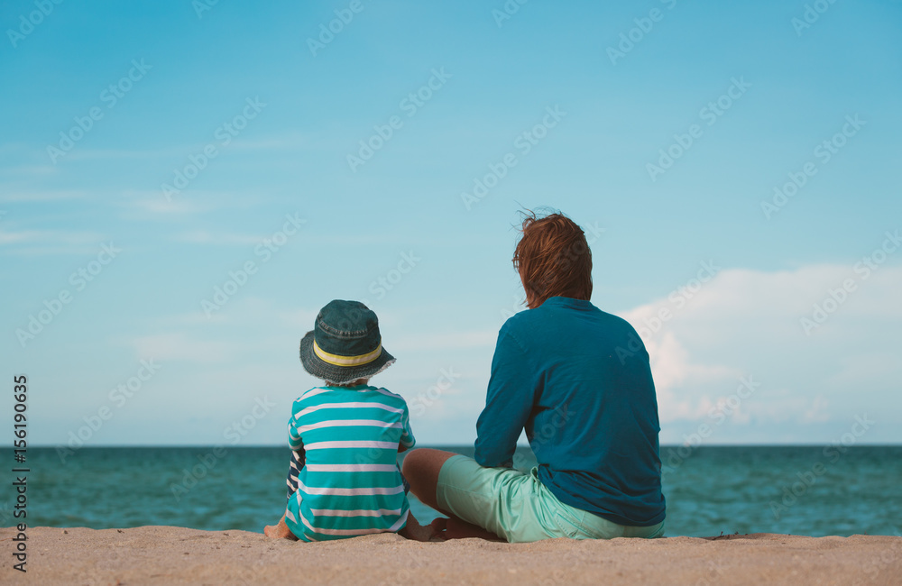 father and little son talking on beach