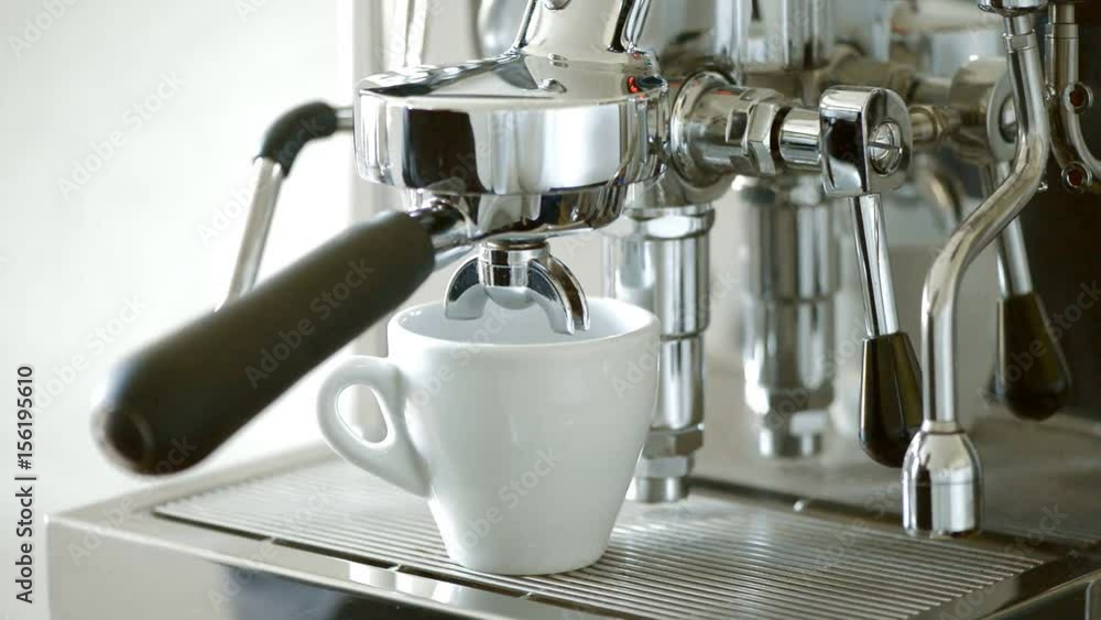 Espresso from a coffee machine. Big cup. With barista hand. Espresso from a coffee machine. Big cup. With barista hand.