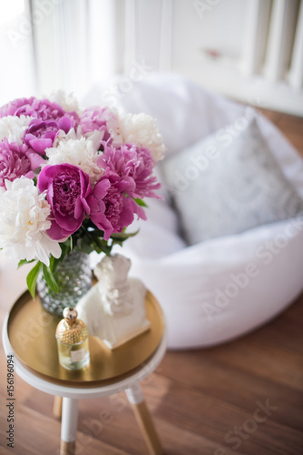 home decoration, fresh pink peonies on coffee table in white roo